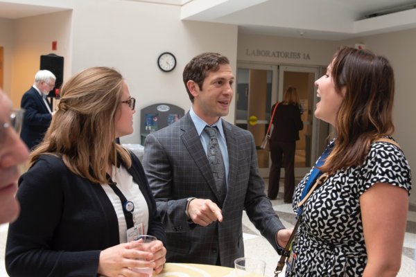 May 30, 2018 - Co-author and MGG co-director Dr. Panagis Galiatsatos greets MGG Advisor Kirsten Gercke and intern Amber Follin at his book reveal.