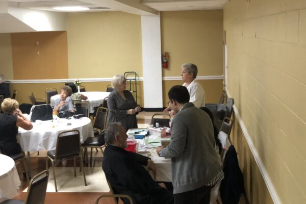 The priest of St. Nicholas Greek Orthodox Church receiving the first flu vaccine shot for our flu vaccine outreach project!